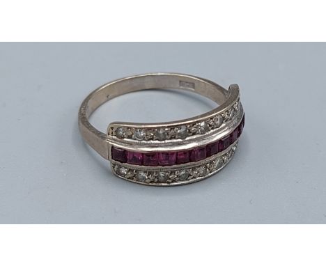 An 18ct gold ring set with a central row of Rubies and two rows of diamonds, 4.8gms, ring size T 