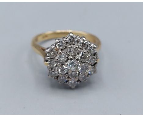 An 18ct gold Diamond cluster ring with a central Diamond surrounded by Diamonds, 4.7gms, ring size I 