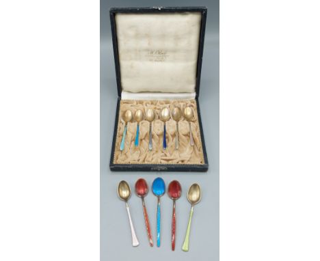 A set of six 930 silver and enamel decorated spoons in fitted case together with five other spoons 