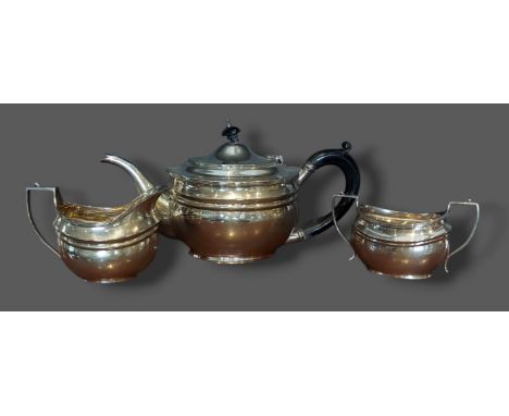 A London silver teapot together with a matching two handled sucrier and cream jug, 24ozs