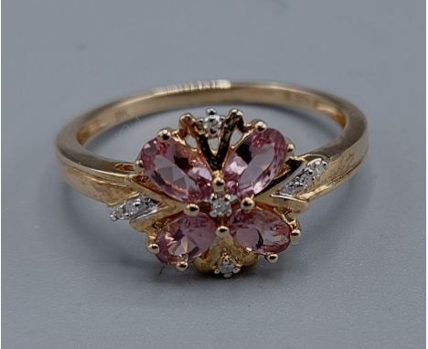 A 9ct gold diamond and pink stone set flower head cluster ring, ring size R, 2.5gms 