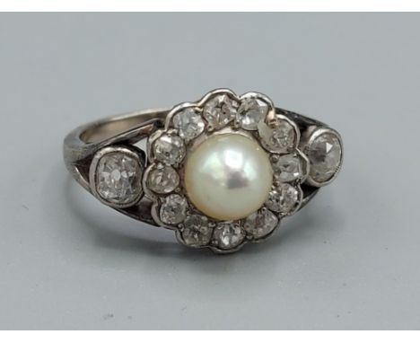A white gold ring set with a central Pearl surrounded by Diamonds with Diamond shoulders, 4gms, ring size M 