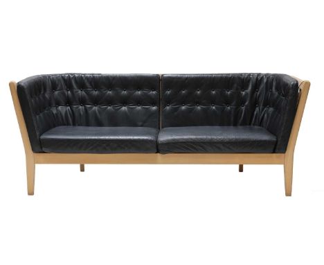 A three seater leather settee, by Stouby, with a stick back frame, 155cm wide 70cm deep 78cm high, seat 38cm