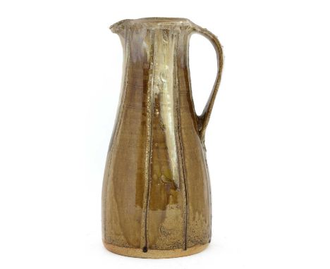 *Jim Malone (b.1946), a glazed stoneware jug, with a two-tone trailing glaze, with vertical incised panels, artist's monogram