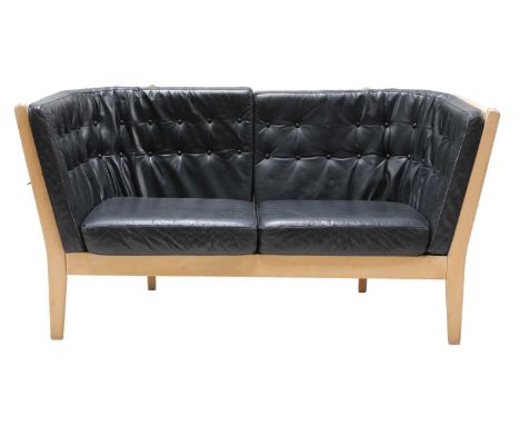 A two-seater leather settee, by Stouby, with a stick back frame, 198cm wide 70cm deep 78cm high, seat 35cm