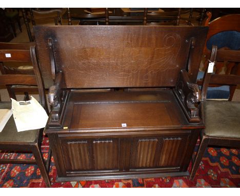 A mid 20th Century carved and stained oak monk's bench.