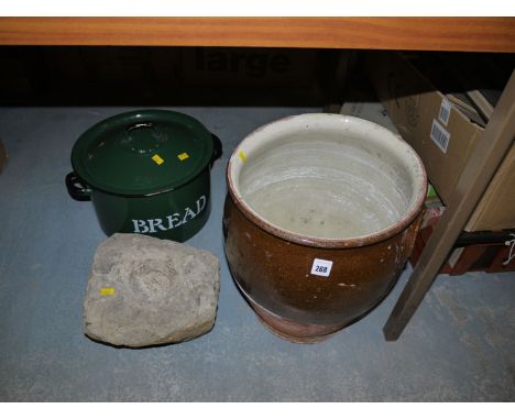 A glazed earthenware storage jar; a stone grinding bowl; a modern enamel bread bin; etc.