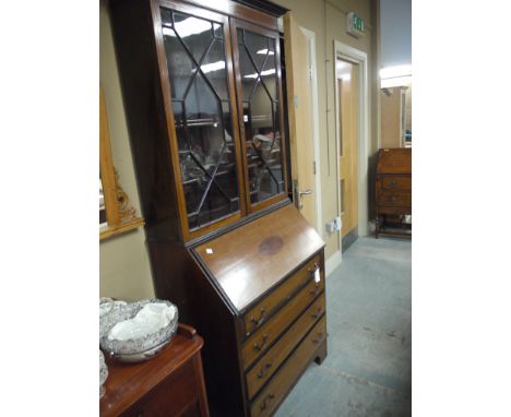 An Edwardian inlaid mahogany bureau bookcase, with flared cornice above two glazed panel doors enclosing adjustable shelves, 