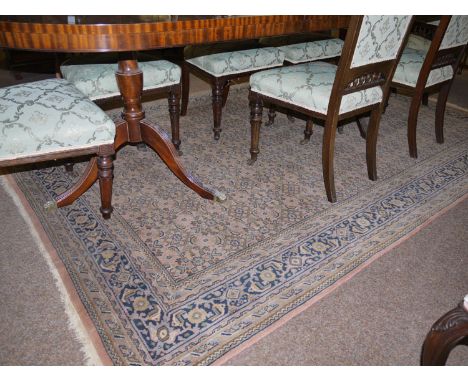 A Persian style carpet with repeated floral design to field.