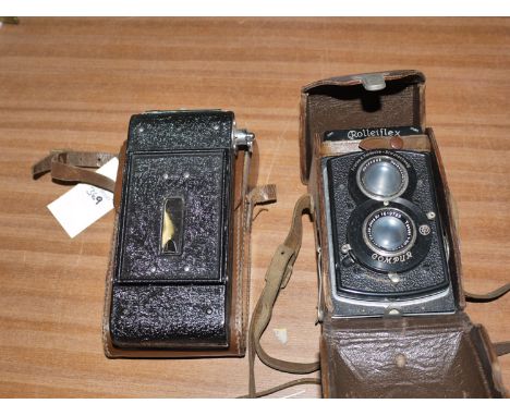 A Rolleiflex Compur camera in leather case; and a silver Sohomyna long distance camera.