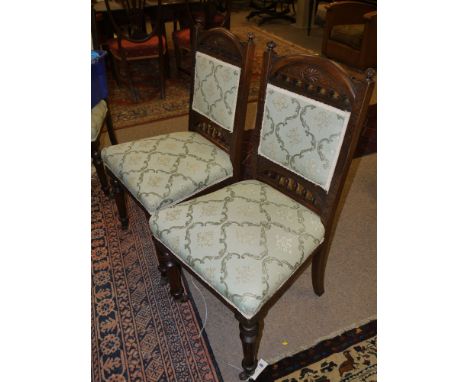 A set of eight Victorian carved and stained mahogany dining chairs, with carved, pierced and arched cresting rails, the seats