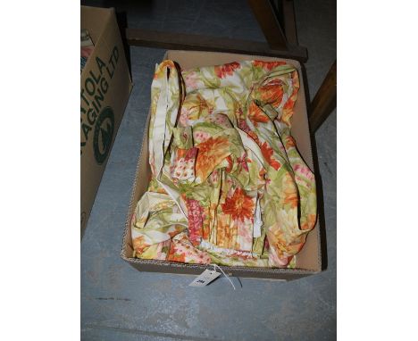 A pair of modern lined floral patterned curtains.