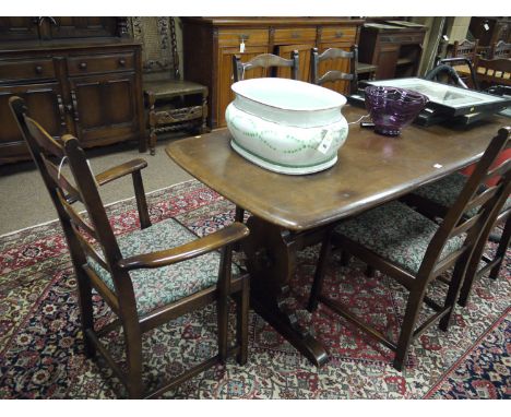 A seven-piece Ercol dining suite, comprising: refectory style dining table, buffet style sideboard, a set of four plus one la