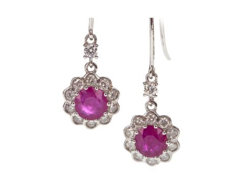 PAIR OF RUBY AND DIAMOND EARRINGS, each set with a round ruby within a round brilliant cut diamond halo, suspended from a sin