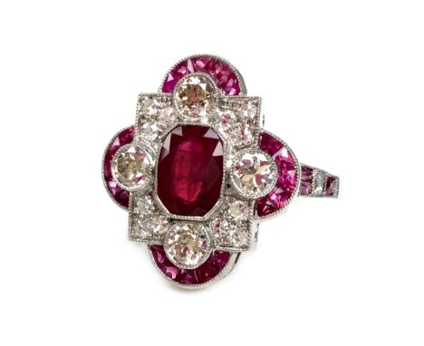 RUBY AND DIAMOND RING, the central ruby flanked by round brilliant cut diamonds and crescent sections set with tapered rubies