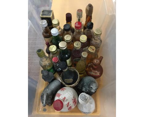 A COLLECTION OF MAINLY WHISKY MINIATURES SOME BEING IN COLLECTABLE CERAMIC CONTAINERS 