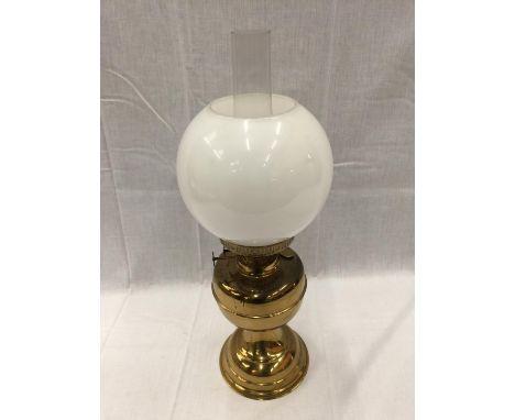 A HEAVY BRASS OIL LAMP WITH GLASS CHIMNEY AND MILK GLASS SHADE, HEIGHT APPROX 50CM 