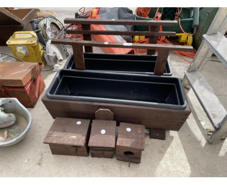 TWO WOODEN TROUGH PLANTERS AND THREE WOODEN BIRD HOUSES 