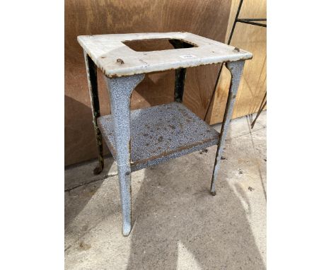 A VINTAGE CAST STOOL WITH LOWER SHELF 