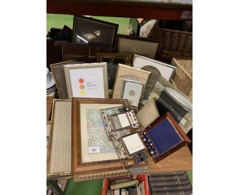 A QUANTITY OF PHOTO FRAMES, A FRAMED PRINT AND A FRAMED TAPESTRY 