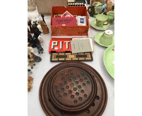 A COLLECTION OF GAMES TO INCLUDE TWO WOODEN SOLITAIRE BOARDS, DARTS, CARDS, CRIBBAGE BOARD, ETC 