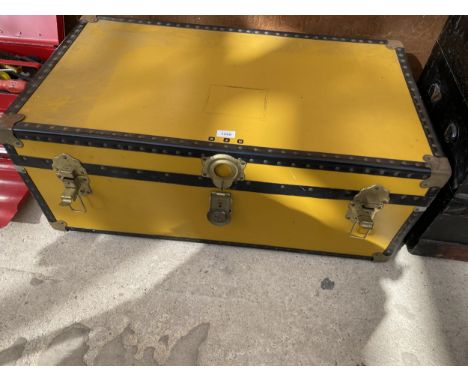 A VINTAGE TRAVEL TRUNK CONTAINING A QUANTITY OF MATERIAL 