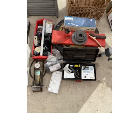 AN ASSORTMENT OF TOOLS TO INCLUDE A SPARE TYRE, STRAPS, A FOOT PUMP AND A SOLDERING IRON ETC 