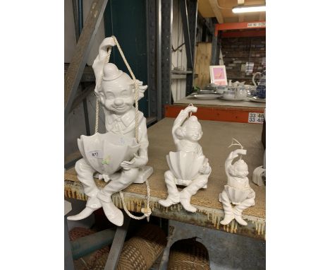A SET OF THREE WHITE CERAMIC HANGING CLOWNS 