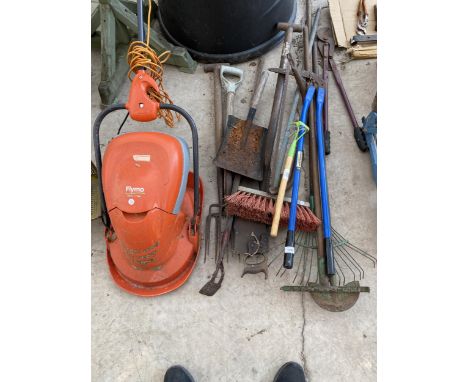 AN ASSORTMENT OF GARDEN TOOLS TO INCLUDE A BOW SAW, FORKS RAKES AND A A FLYMO AND VAC ELECTRIC LAWN MOWER 