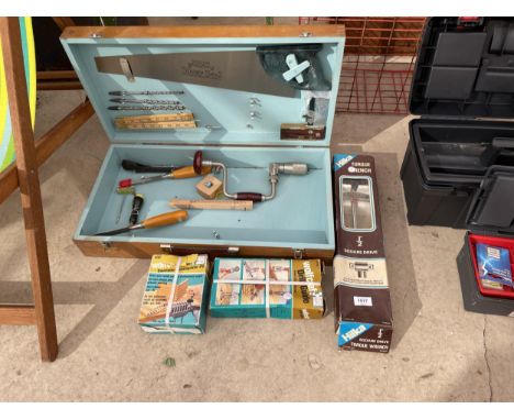 A VINTAGE WOODEN JOINERS CHEST WITH TOOLS TO INCLUDE A BRACE DRILL, SAWS AND A TORQUE WRENCH ETC 