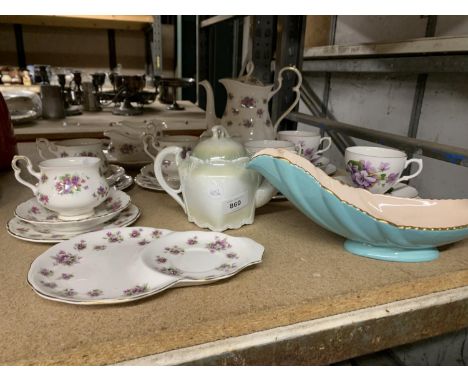 A ROYAL ALBERT 'VIOLETTA' PART TEASET INCLUDING CUPS, SAUCERS, PLATES, TEAPOT, SUGAR BOWL, CREAM JUG, SALT AND PEPPER POT, PL