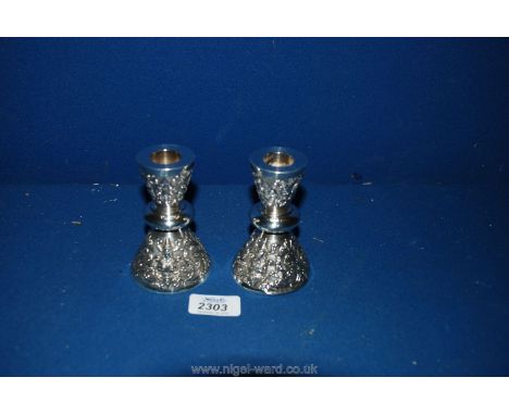 A pair of Silver Candlesticks, 4'' tall, marked Thailand Sterling.