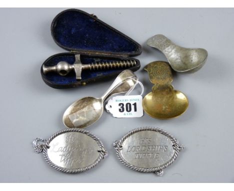 A cased white metal Champagne tap, a pair of oval white metal spirit labels - 'His Lordship's Tipple' and 'Her Ladyship'sTipp