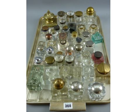 Approximately forty glass square based inkholders, mostly with lids along with a brass inkwell etc