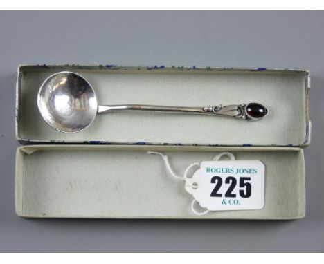 A beaten silver decorative spoon with circular bowl and shaped handle with floral decoration and oval garnet, Edinburgh 1960'