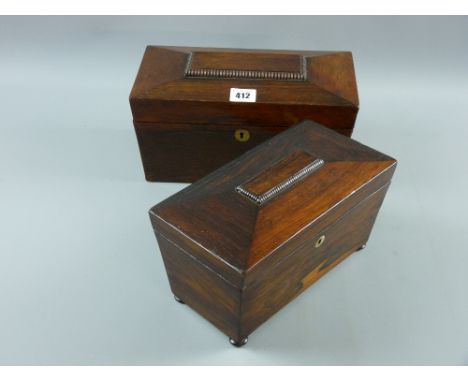 A Victorian rosewood sarcophagus shaped tea caddy with mother of pearl escutcheon on turned squat feet with twin lid interior