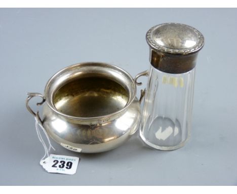 A twin handled Continental silver porringer bowl on a shallow pedestal and of waisted form, 5.2 ozs and a glass dressing tabl