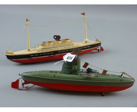 A tinplate clockwork model of a twin masted cruise liner, marked to the base 'Made in Germany, US Zone', 13 x 31 cms with a n