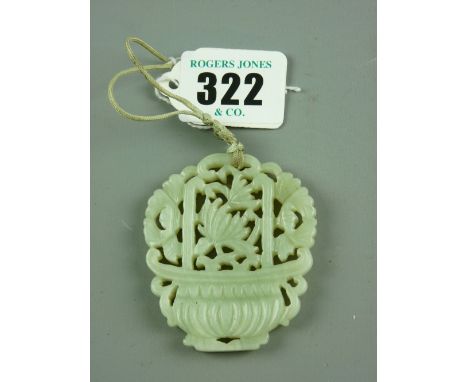 A green jade pendant in the form of a vase of flowers, 6 x 5 cms