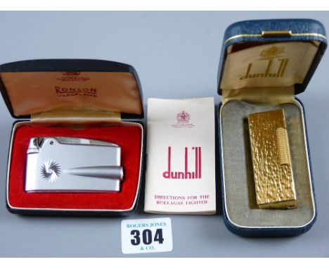 A mint and cased Dunhill Rollagas cigarette lighter, the case in yellow metal bark effect and a cased Ronson Varaflame cigare