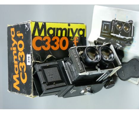 A Mamiya C330 Professional 6x6 twin lens Reflex camera, boxed with instructions and carrying strap