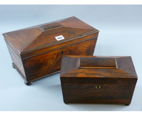 A Regency rosewood sarcophagus shaped tea caddy with brass escutcheon on turned bun feet having twin interior lidded canister