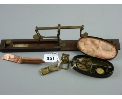 A mahogany cased set of sovereign and half sovereign scales and a tin enclosed traveller's scales with two weights and two br