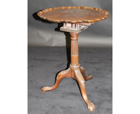 An early 19th Century mahogany tripod table, the plain top with pie crust edge above a birdcage, to fluted column support, ra