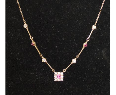 A ruby and diamond necklace, the central pendant set with a square ruby within eight diamonds, suspended below interspersed r