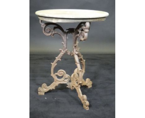 A Victorian cast iron garden table, the marble top above a tripod base with scrolling decoration 60 cm diameter x 75cm high 