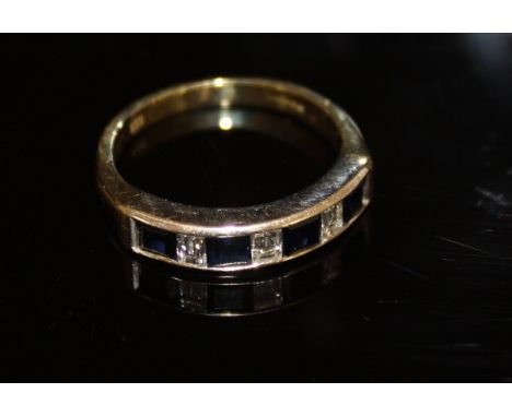 An un-marked gold dress ring with interspersed diamonds and sapphires, approx 4.7 g total weight, size R