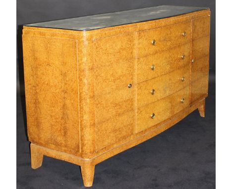 LIANE J FLAMENT - an early 20th Century Art Deco amboyna serpentine fronted commode, the top with removable mirror, the four 