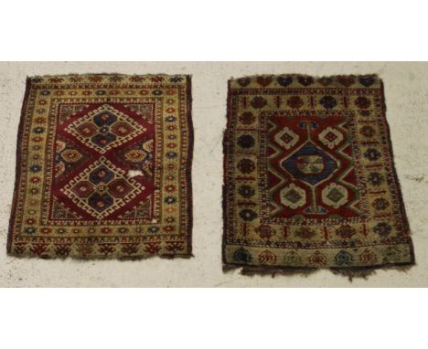 A Caucasian rug, the central panel set with two lozenge-shaped medallions and geometric pattern on a purple ground, within a 