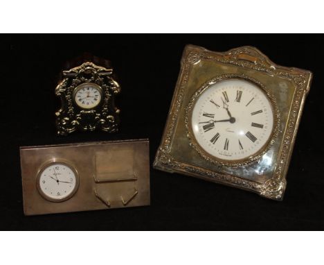 A modern silver-mounted mantle clock of shaped form, decorated with floral, foliate and C scroll decoration (by Carrs of Shef
